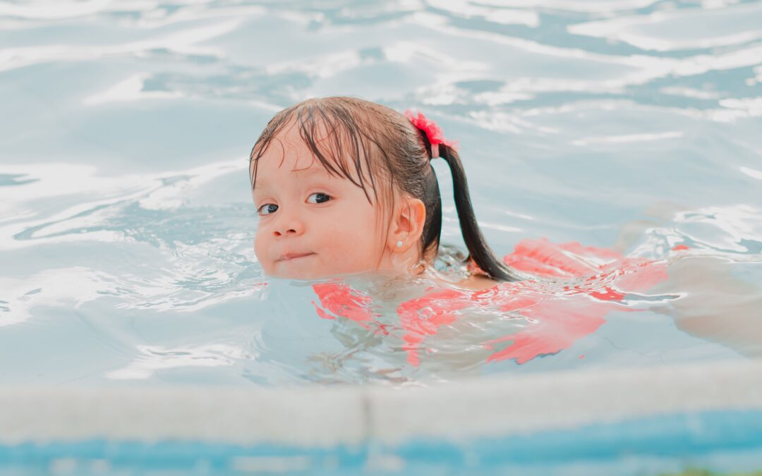 Girl swimming in a pool.