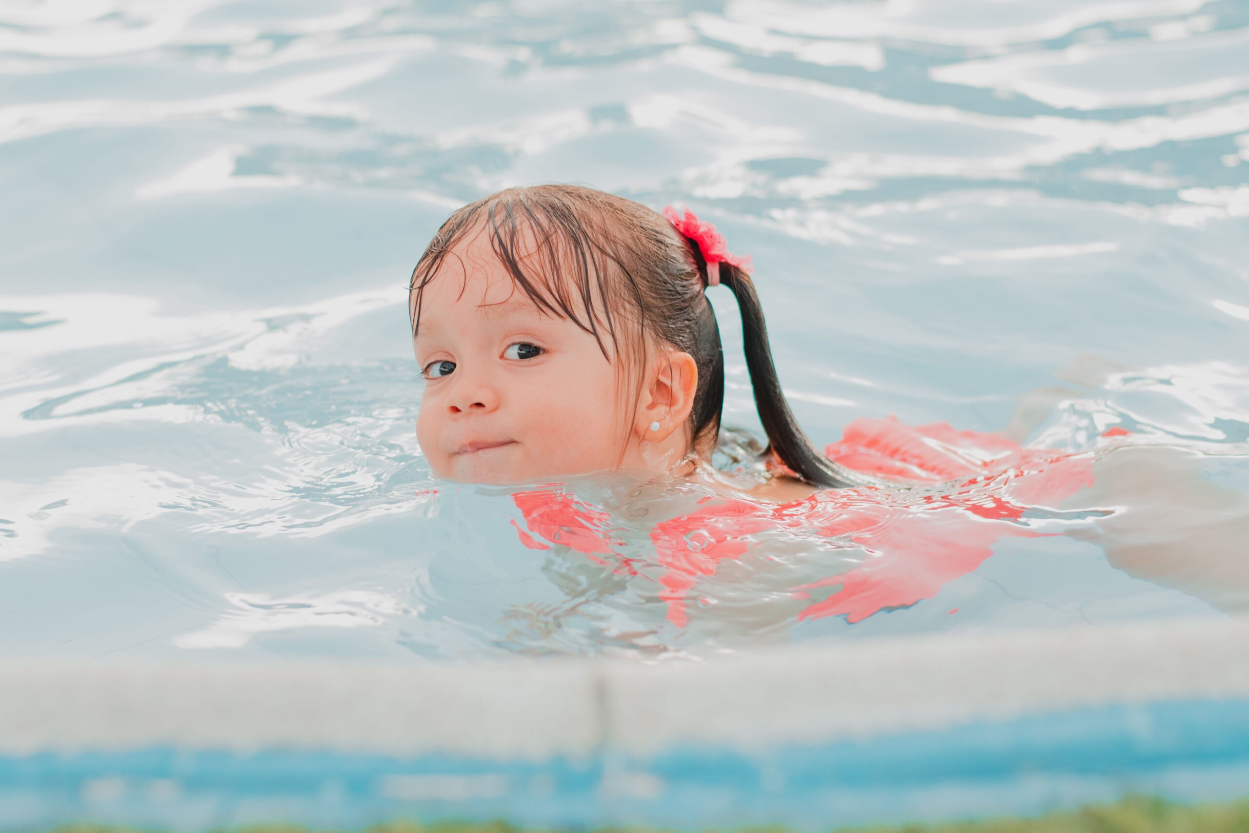 Girl swimming in a pool.